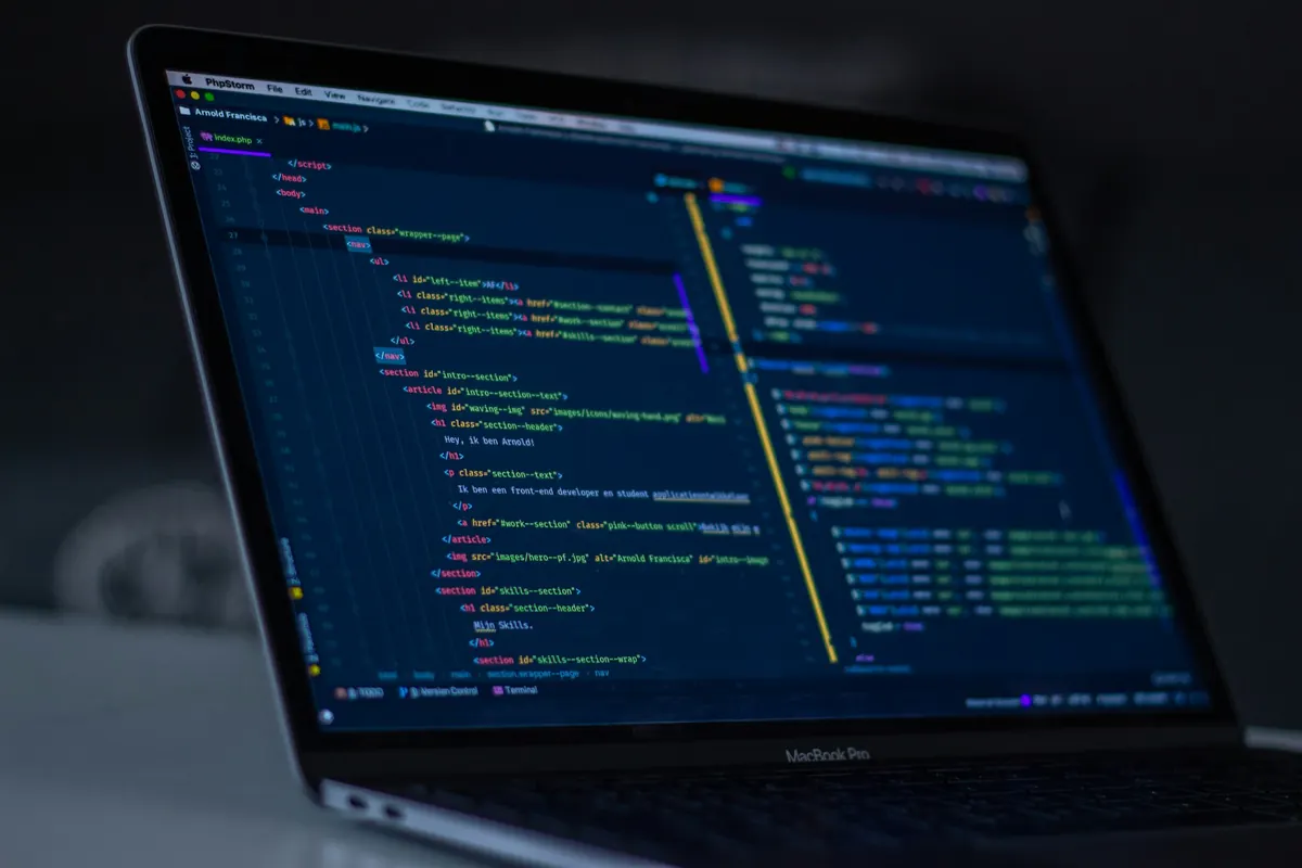 A laptop screen showing source code in a dark editor